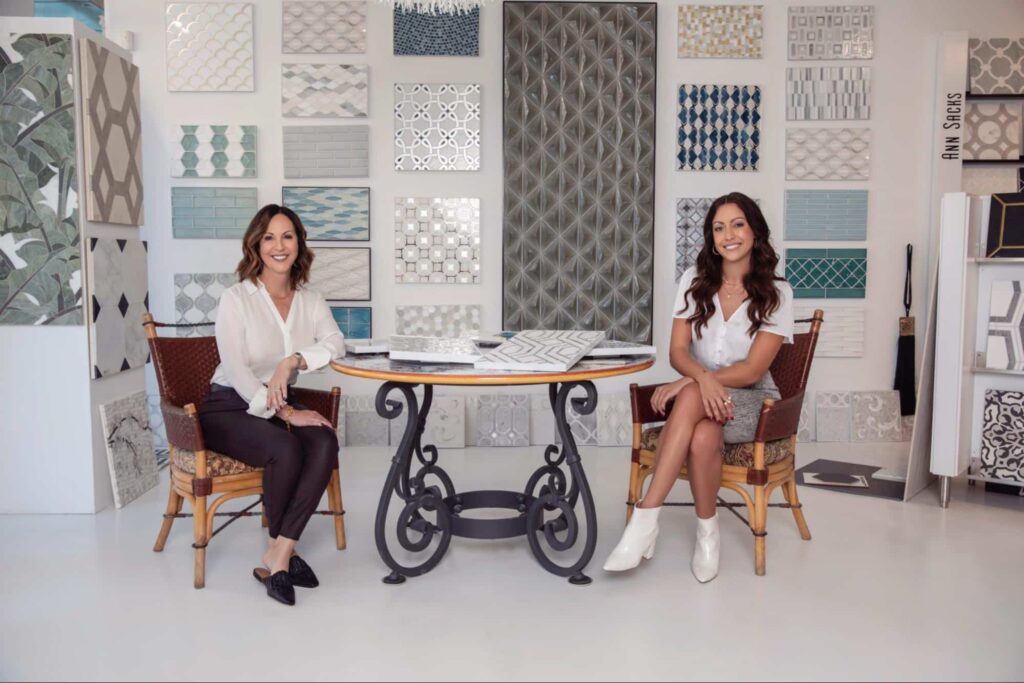 Trade Mark Interiors designers Tracee and Kristen pose in a designer tile shop. 