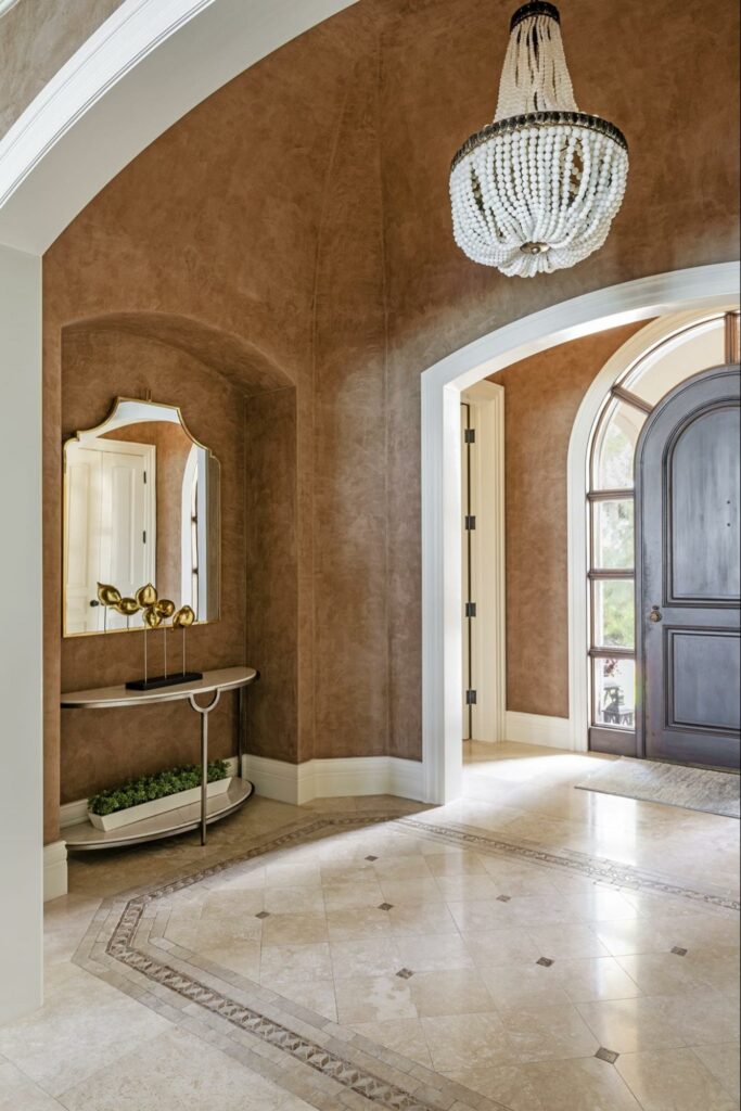 a luxury and grand entry way featuring a fun and coastal themed chandelier 